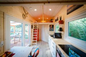 a tiny house with a kitchen and a table at Tiny House - Birne in Wald