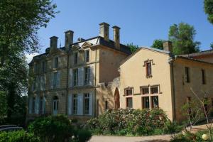 an old house with turrets on top of it at L'abbaye du château du Vallier in Langoiran