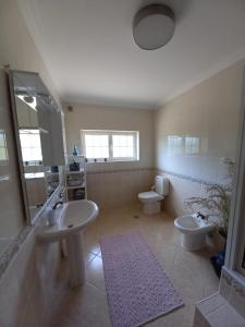 a large bathroom with two sinks and two toilets at Casa do Vale in Vila Flor