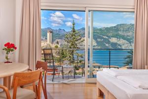 a hotel room with a view of the ocean at Eco Hotel Ariston in Malcesine