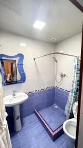 a bathroom with a shower and a sink at Khan hotel in Khiva