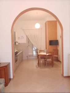 a kitchen and dining room with a table and chairs at A' Ches du' Mestr 1 in Montalbano