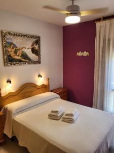 a bedroom with a bed with towels on it at Casa Rural Reyes in Nuévalos +34 photos