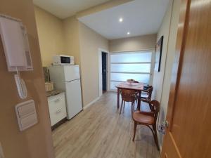 mały pokój ze stołem i kuchnią w obiekcie Apartamentos Dunamar w mieście Noalla