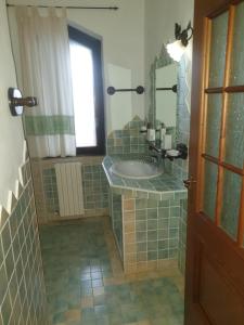 a bathroom with a sink and a mirror at Angelo e Arcangela in Telti