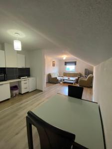 a living room with a table and a couch at House Enio in Bihać +10 photos