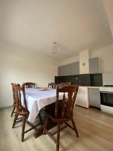 a kitchen with a table and chairs in a room at House Enio in Bihać