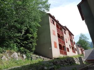 a large building with windows and a tree at Agréable appartement avec balcon dans résidence calme in Cauterets