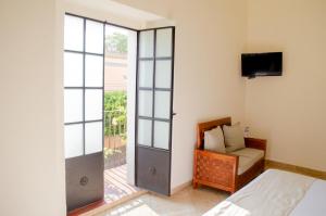 a bedroom with a bed and a sliding glass door at Hotel Catedral in Cuernavaca