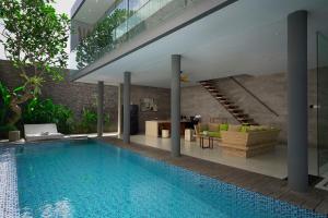 a house with a swimming pool and a living room at Sandhya Villa Canggu Echo Beach in Canggu