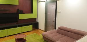 a living room with a couch and a television at Modern in Piteşti