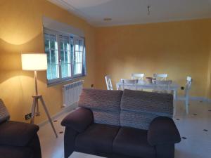 a living room with a couch and a table at Casa da Pioxa in Camariñas +18 photos