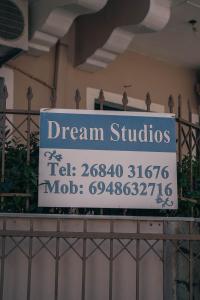 a sign for dream studios on top of a fence at Dreams Studios Parga in Parga