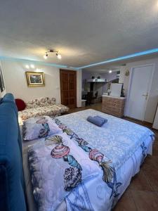 a bedroom with a large bed with a blue blanket at Taverna coctel in Poreč