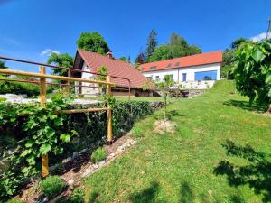 a garden with a fence and a house at Lake View Holiday Home in Cerknica