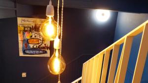 a couple of lights hanging from a wall at Mon P'tit Hôtel in Le Grau-dʼAgde