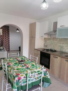a kitchen with a table with a table cloth on it at A casa di Ro` in Agrigento