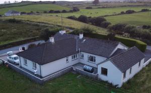 an aerial view of a white house in a field at Lahinch View in Doolin