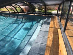 LA MAISON DE LA DUNE - Chambres Climatisées - Jacuzzi 1ère séance offerte - Piscine chauffée avec Abri Amovible - Plage située à 200m, accès direct par le bois内部或周边的泳池
