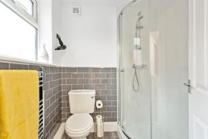 a bathroom with a toilet and a shower at Spacious & Central Entire Home in Nottingham