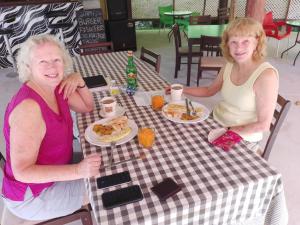 two older women sitting at a table eating breakfast at Natty Tropical Valley in Roseau