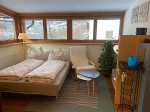 a living room with a couch and a chair at Apart Linde in Hopfgarten im Brixental