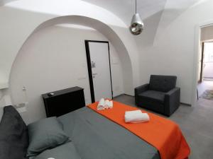 a living room with a bed and a chair at La Casa di Orlando in Catania