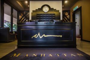 a bar with a sign that reads amsterdam with a clock at Manhattan Business Hotel Damansara Perdana in Petaling Jaya