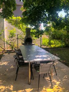 a picnic table with a vase sitting on top of it at Renata Holiday Apartments in Ulcinj
