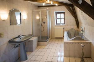 a bathroom with a sink and a shower and a tub at Rißbacher Hof Mansarde anno 1737 in Traben-Trarbach