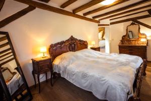 a bedroom with a bed and a dresser and a mirror at Rißbacher Hof Mansarde anno 1737 in Traben-Trarbach