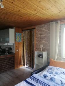 a bedroom with a bed and a brick wall at Spatzennest in Garz-Rügen