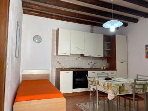 a kitchen with a table and a kitchen with white cabinets at La casa di Andrea in Favignana