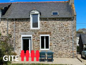 a stone house with a bench in front of it at Gites La Ville Pain in Cancale
