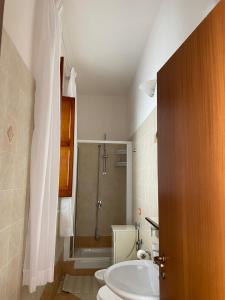 a bathroom with a shower and a toilet and a sink at La casa di Andrea in Favignana