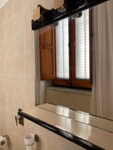 a bathroom with a sink and a mirror at La casa di Andrea in Favignana