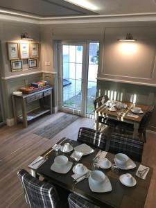 a dining room with a table and chairs and a dining room at Bryn Goleu Bed & Breakfast in Llandudno