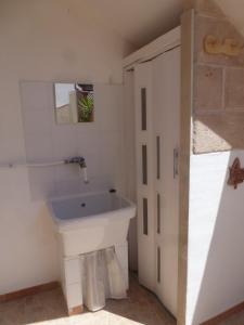 a bathroom with a sink next to a door at La vedetta in San Pietro in Bevagna +40 photos