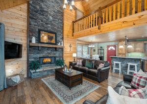 a living room with a couch and a fireplace at Spacious cabin with resort amenities - dog friendly, hot tub, & fireplace - Bear Paw Ridge in Ellijay