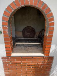 a brick oven with a large object in it at Apartments Medic in Drače