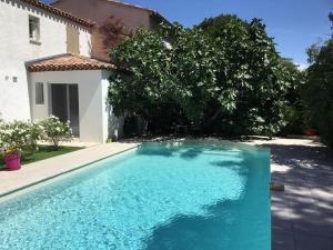 a swimming pool in front of a house at Ste Maxime Villa 5 etoiles Piscine chauffée et jacuzzi in Sainte-Maxime