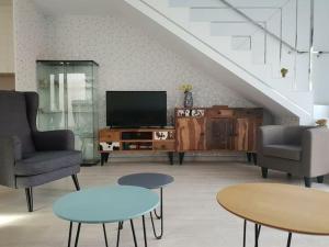 Una sala de estar con un televisor y dos sillas y una mesa. en Espanhouse Villa in Pilar de la Horadada, en Pilar de la Horadada