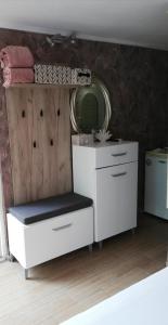 a bathroom with a white dresser and a mirror at Guest House Ivy in Ravda