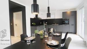 a dining room with a black table and chairs at The Grey House in Kröv