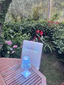 a blue glass jar sitting on a wooden bench at Velamica Resort in Lerici