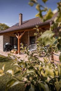 a brick house with a porch with a grill at STODOLA NA VSI in Poděbrady