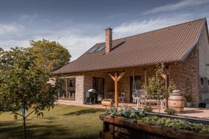a brick house with a roof at STODOLA NA VSI in Poděbrady