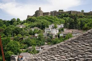 a view of a town with a castle on a hill at Cico Hostel &private room in Gjirokastër
