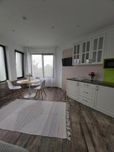 a living room with a table and a kitchen at Accent House in Deva