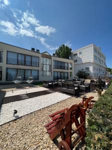 a park bench in front of a building at MIMOZA - Apartaments Panoramic Sea View in Eforie Nord